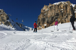 Skiers at the top of the M piste in Courchevel in a private lesson